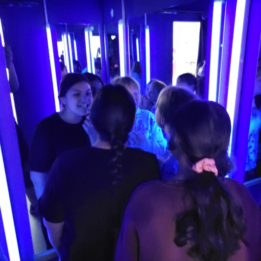 Mädchen stehen in einem Raum mit Blaulicht