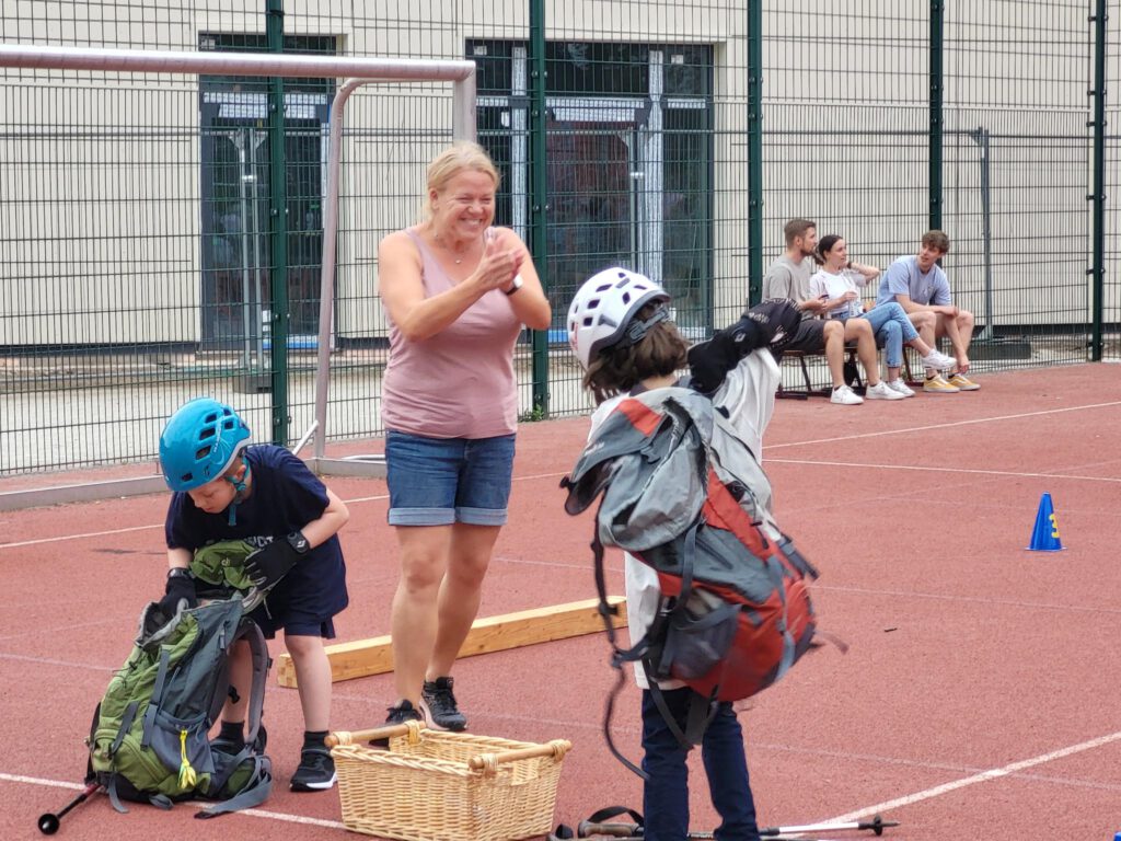 Eine Frau beklatscht zwei Kinder beim Wettkampf