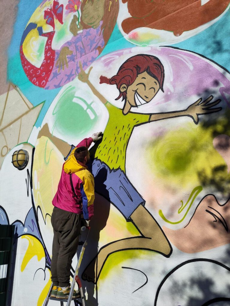 Der Künstler bemalt die hauswand